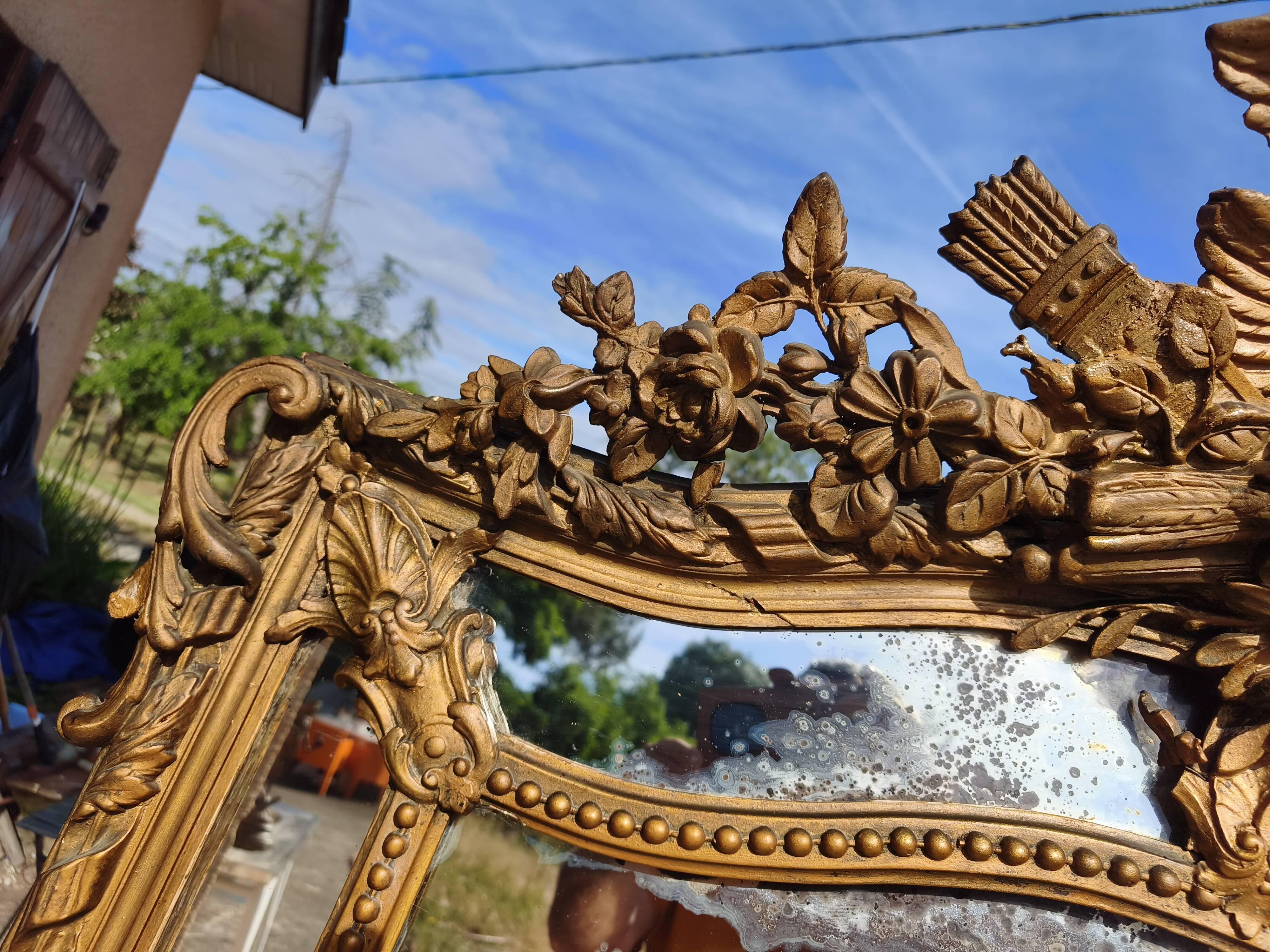 Large closed mirror, 19th century, wood and gilded stucco.