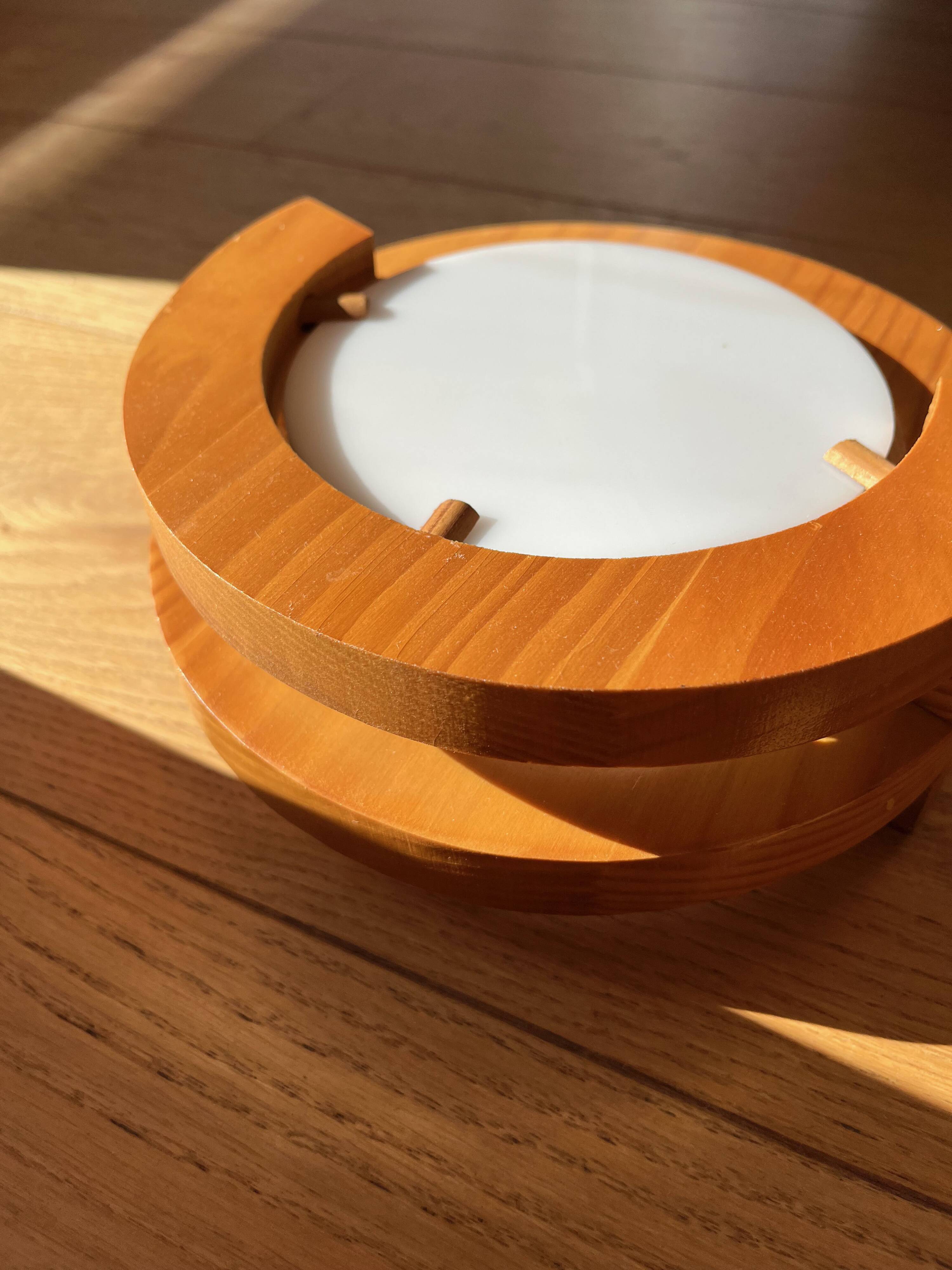 Round pine and plexiglass wall light, 1970s