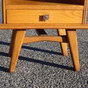 Vintage oak bedside table with tapered legs.