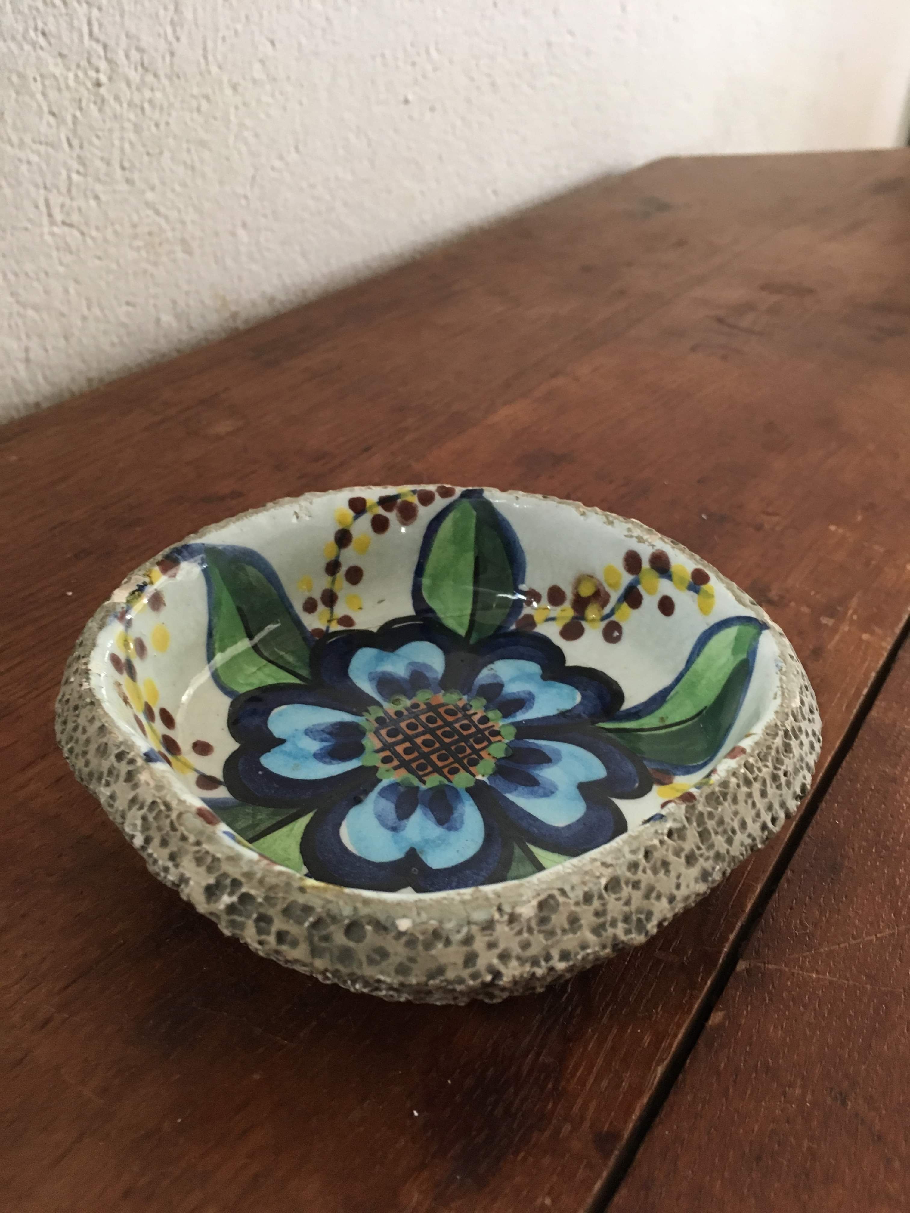 Cup lava foam with blue flower.