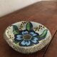 Cup lava foam with blue flower.