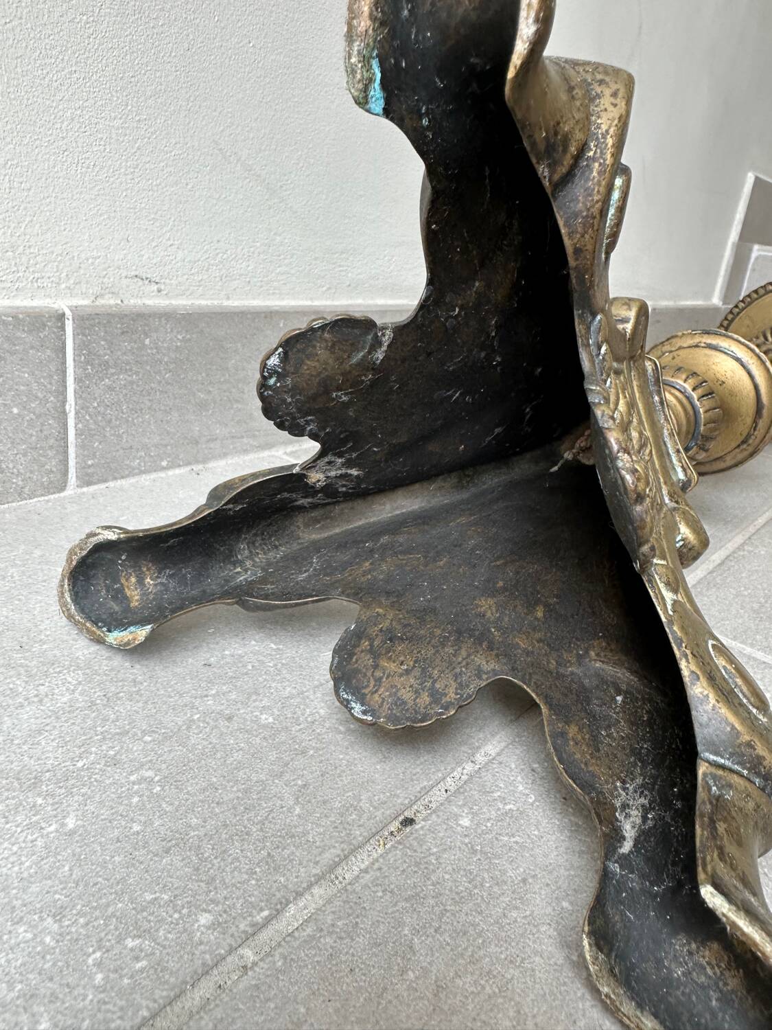 Gilded bronze candlestick with cherub trio decoration