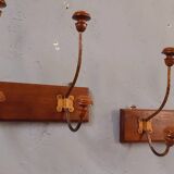 Pair of double coat hooks from the end of the 19th century, circa 1900, in wood and varnished metal