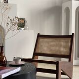 Reclined armchair in canned teak in natural wood
