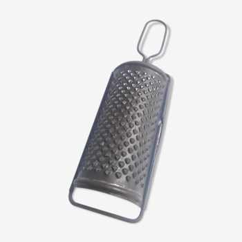 Old rounded metal cheese grater