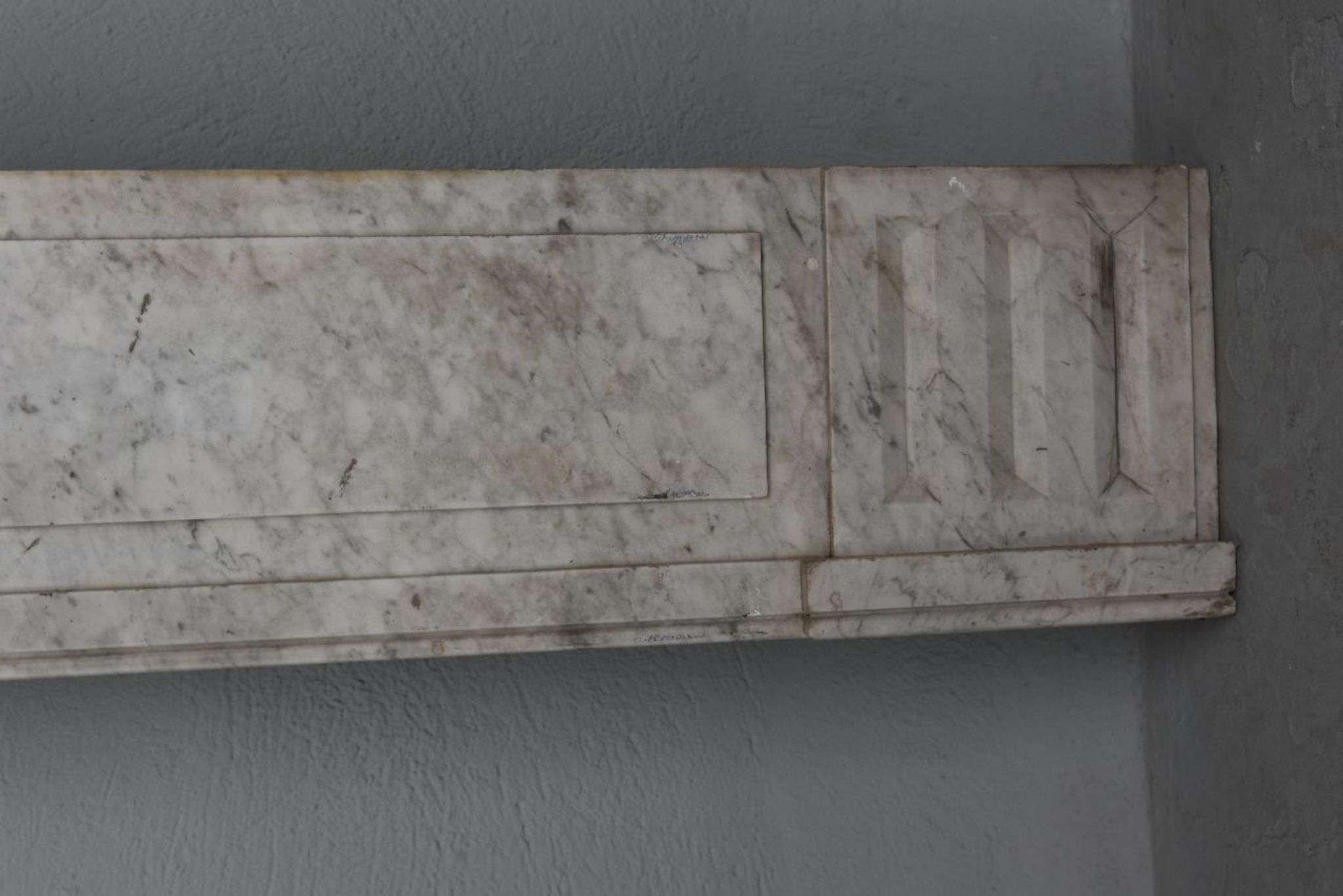 Old fireplace in white marble veined Louis XVI