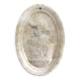 Character on plaster medallion