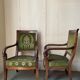 Paire de fauteuils empire en noyer teinté, tissus vert motif de palmette, sculptés têtes de dauphin