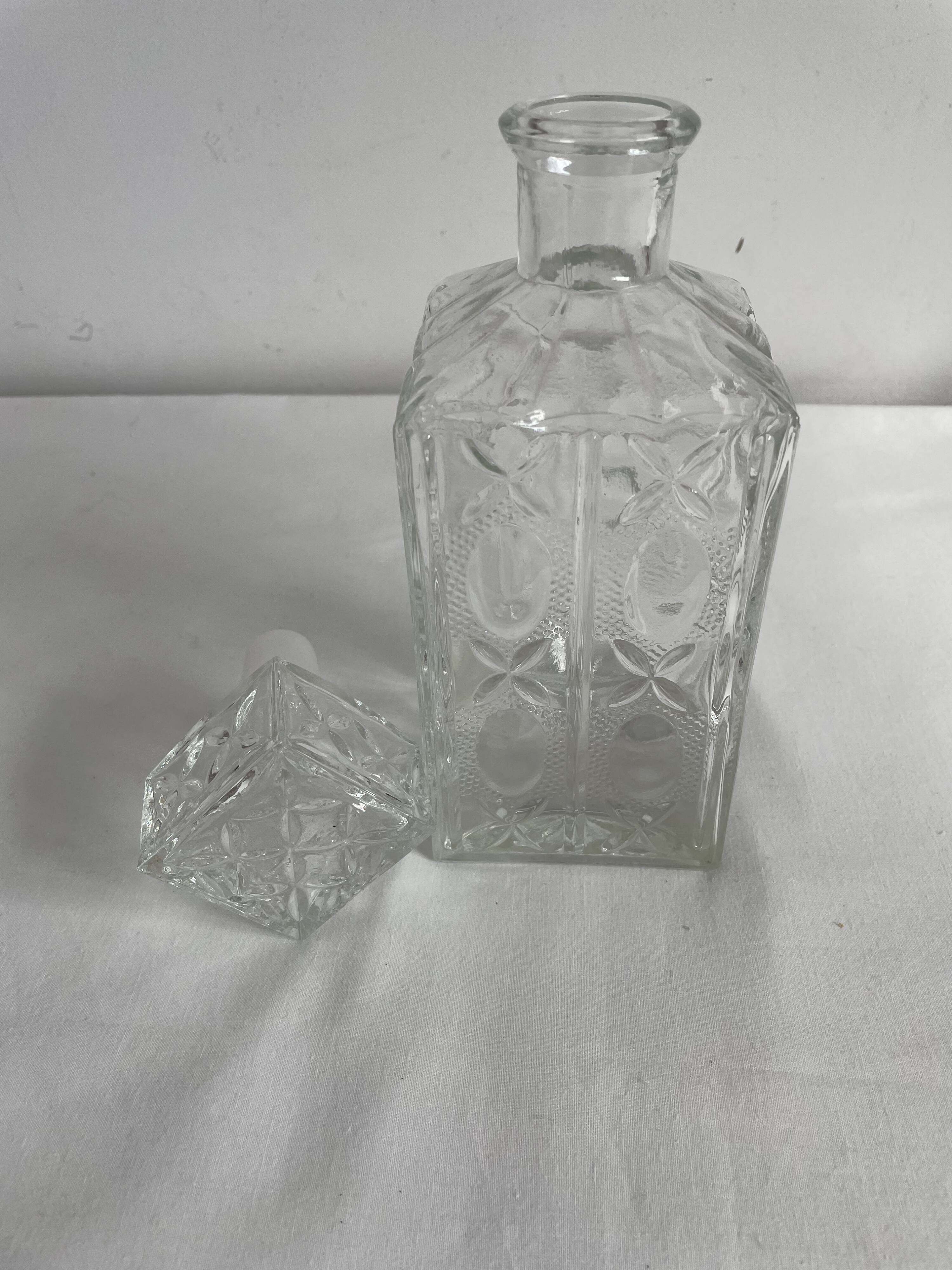 Molded glass carafe, 1960s-1970s, stylized flower decoration, oval, square base, stopper, rosette