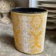 Oval paper bin in woven ochre and grey cotton