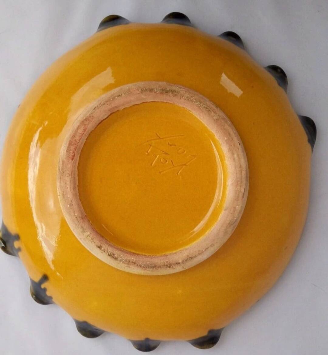 Multicolored earthenware dish signed Yvon Roy