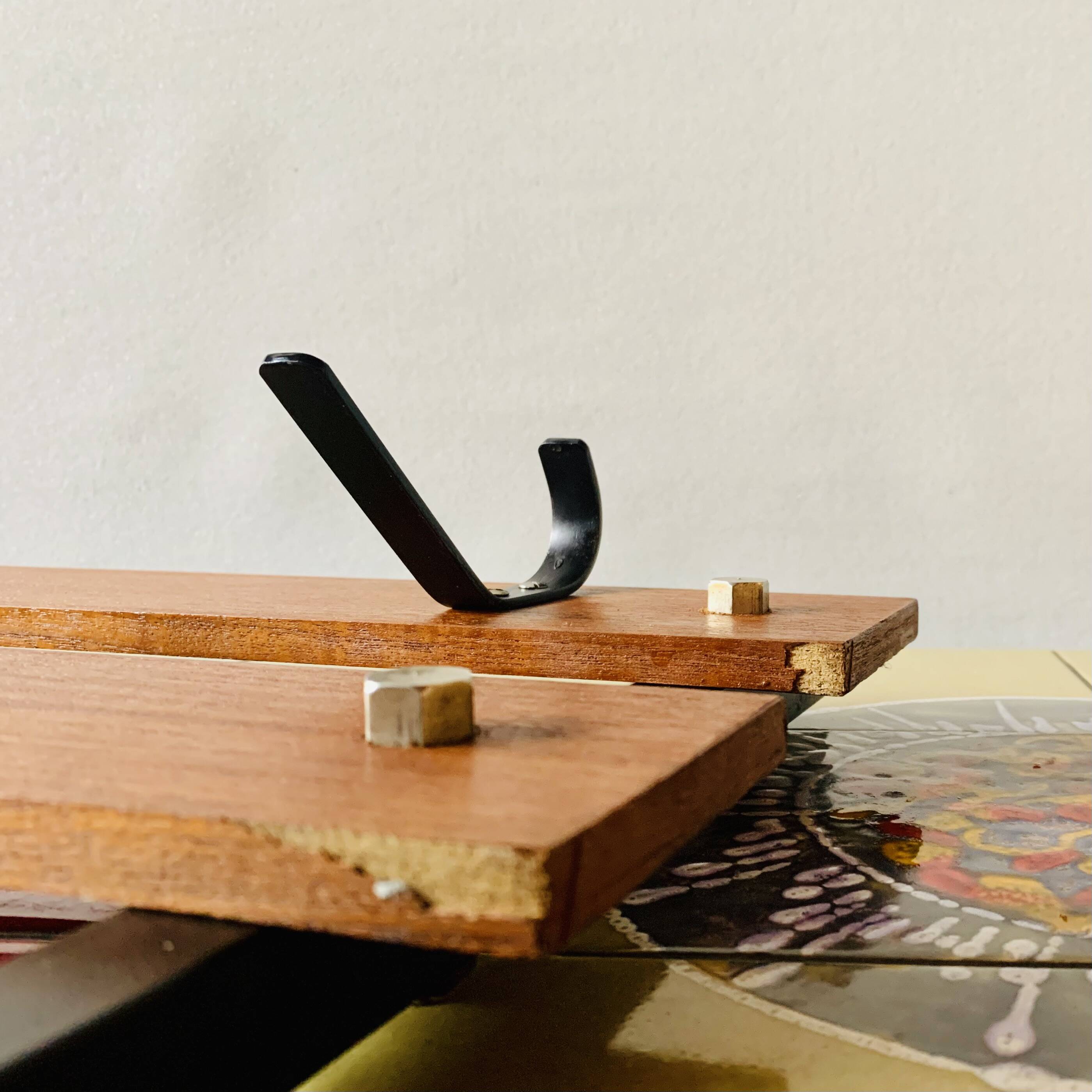 Vintage wall-mounted coat rack in wood and black metal