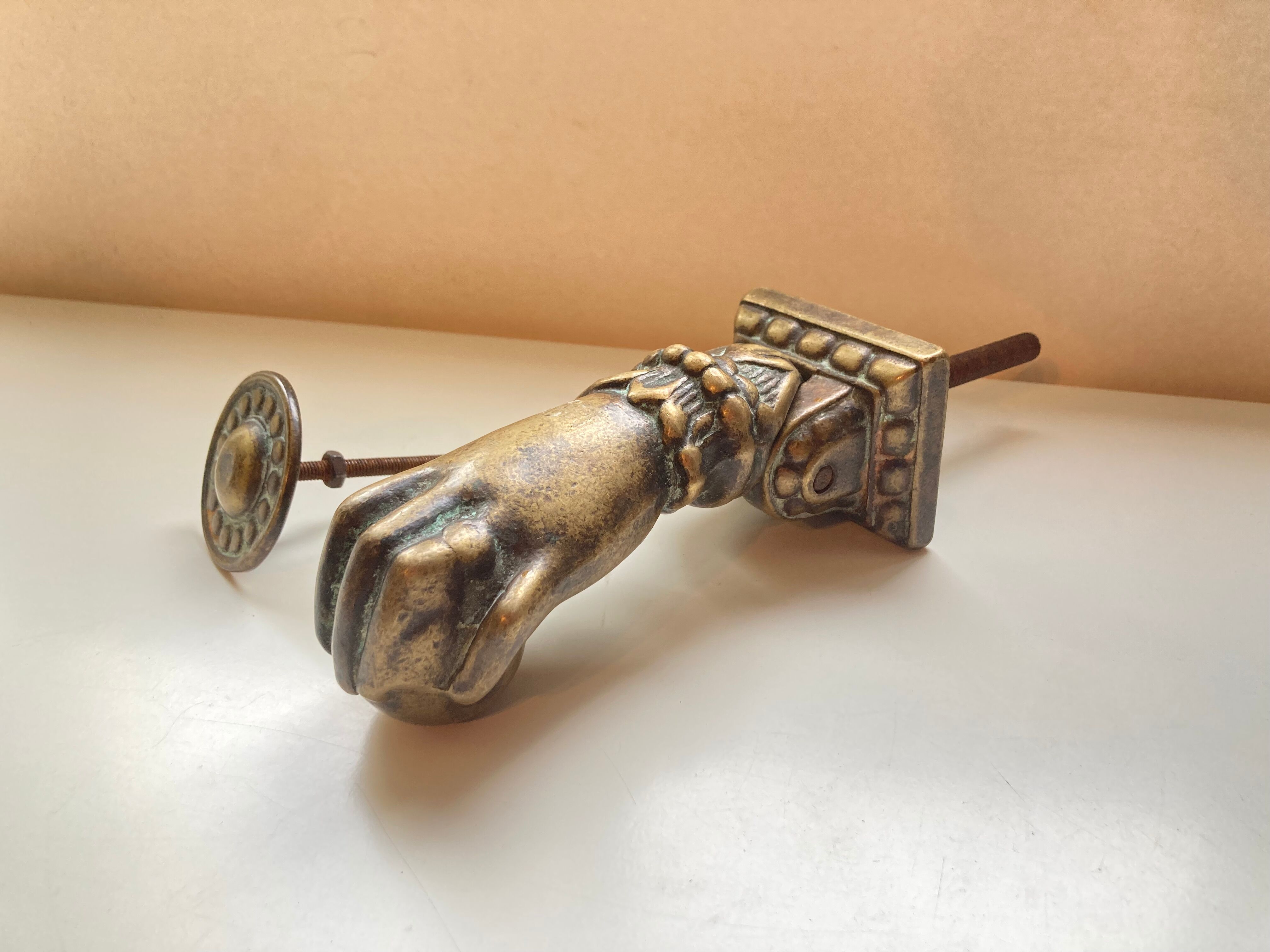 Antique bronze hand-shaped door knocker