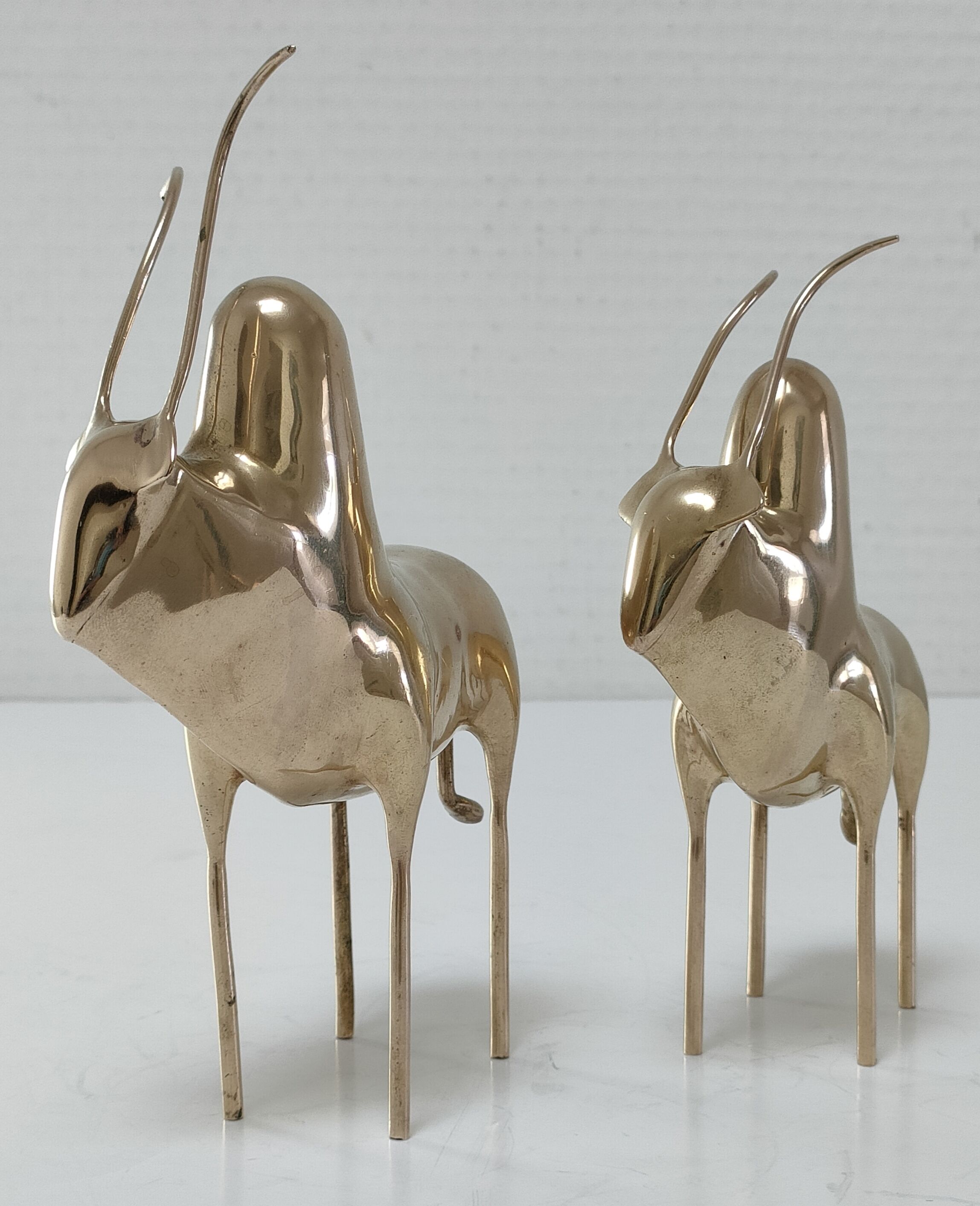 Two stylized zebu with long vintage brass horns