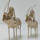 Two stylized zebu with long vintage brass horns
