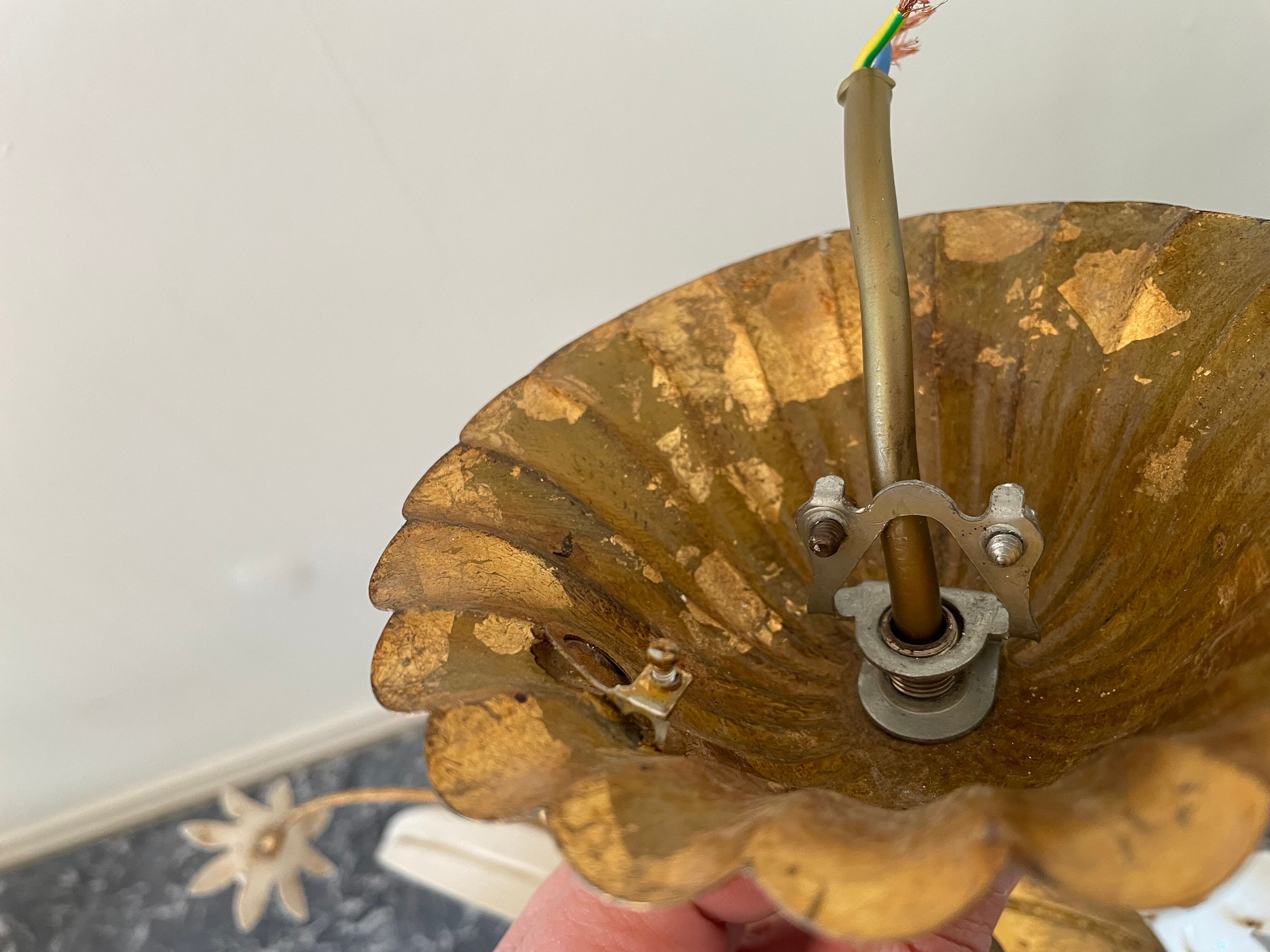 Golden metal chandelier decorated with flowers