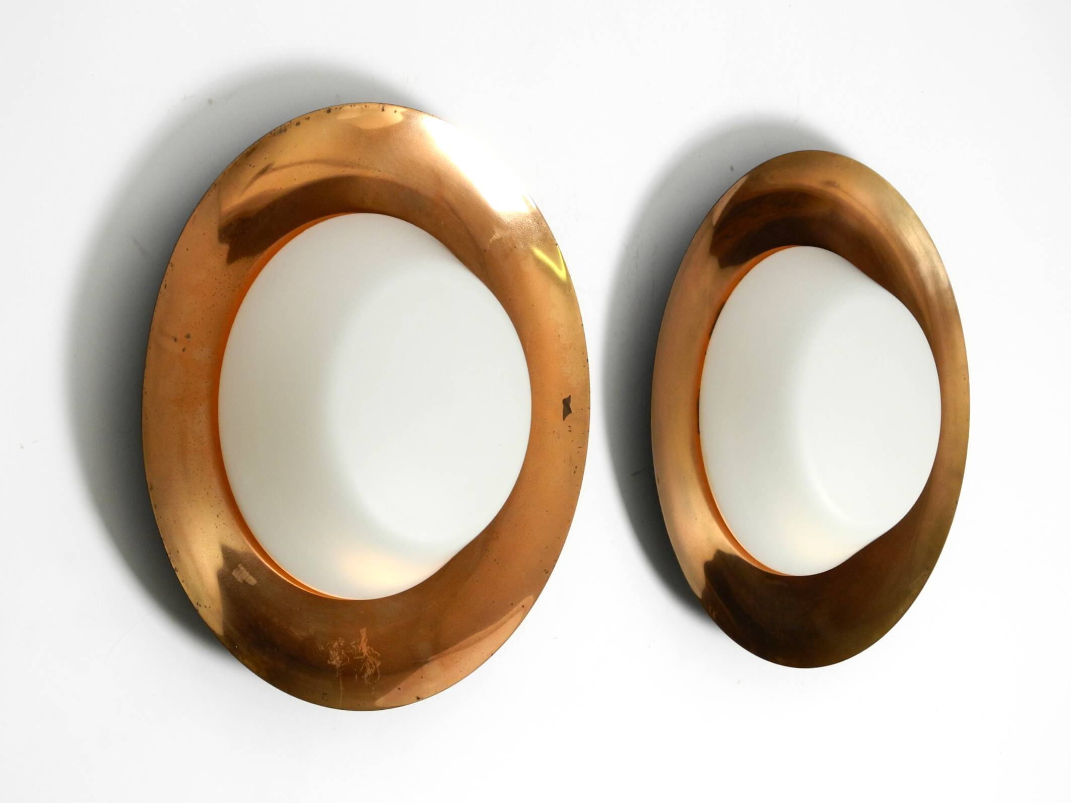 Pair of Mid Century wall or ceiling lamps made of glass with copper-plated