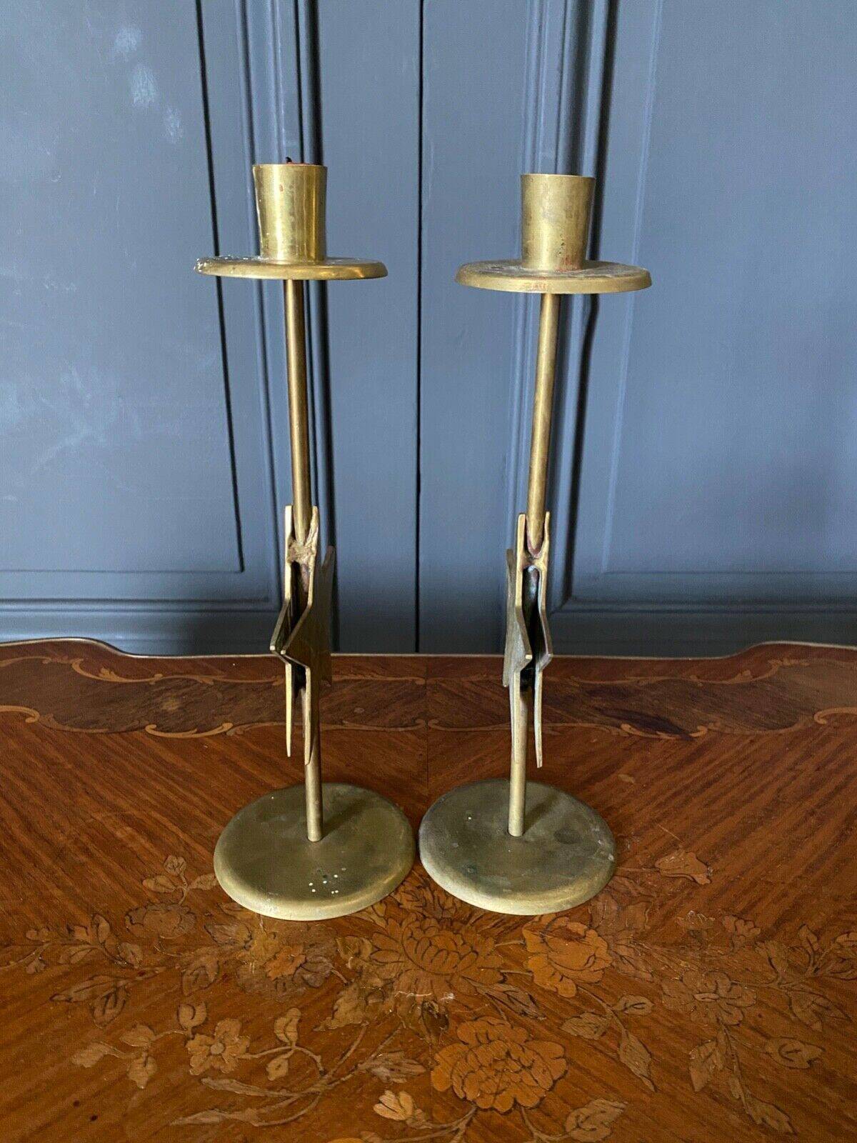 Pair of brass candlesticks decorated with 20th century stars