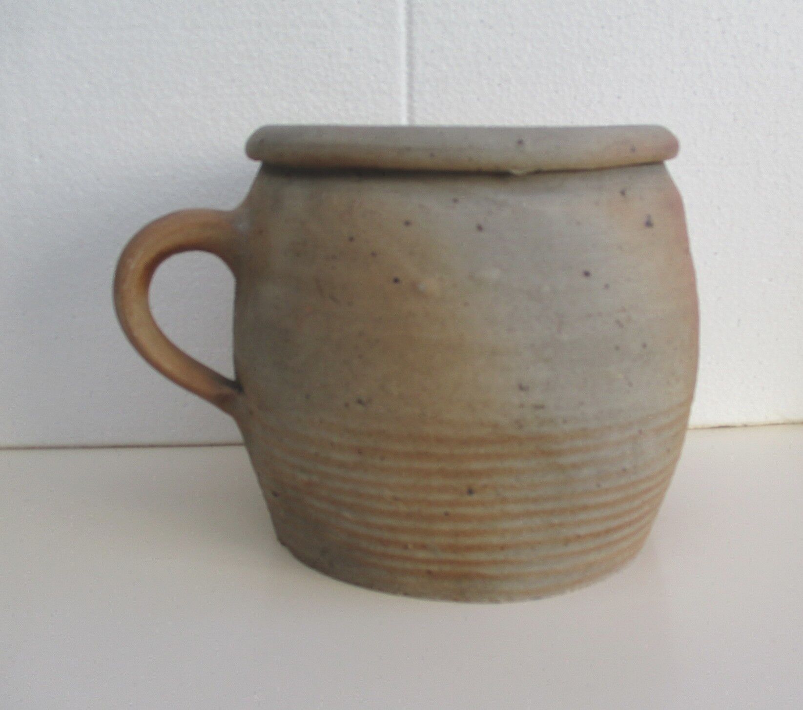Ancient sandstone pot at one handle