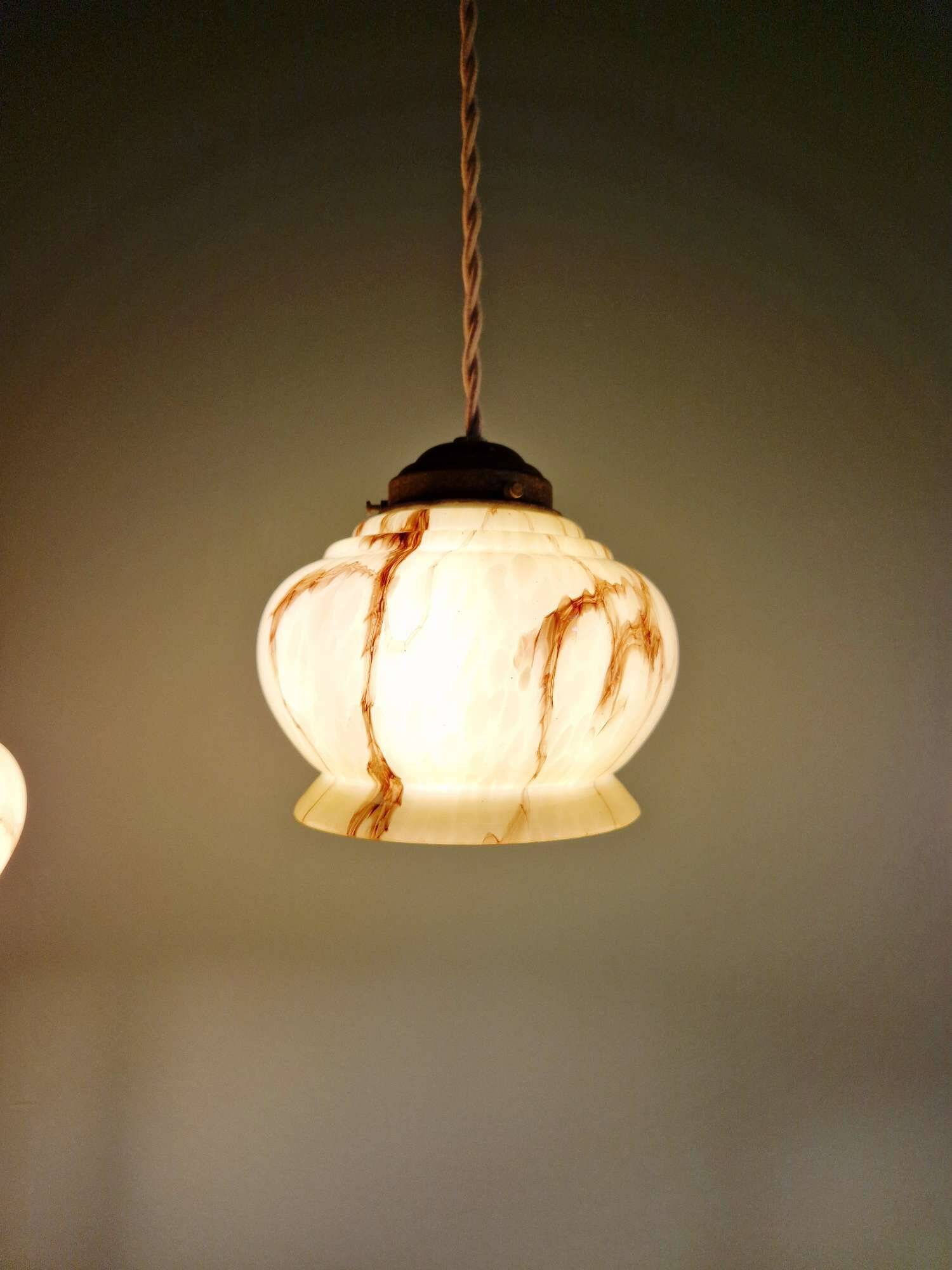 Trio of Art Deco marbled opaline pendant lights, 1920-30