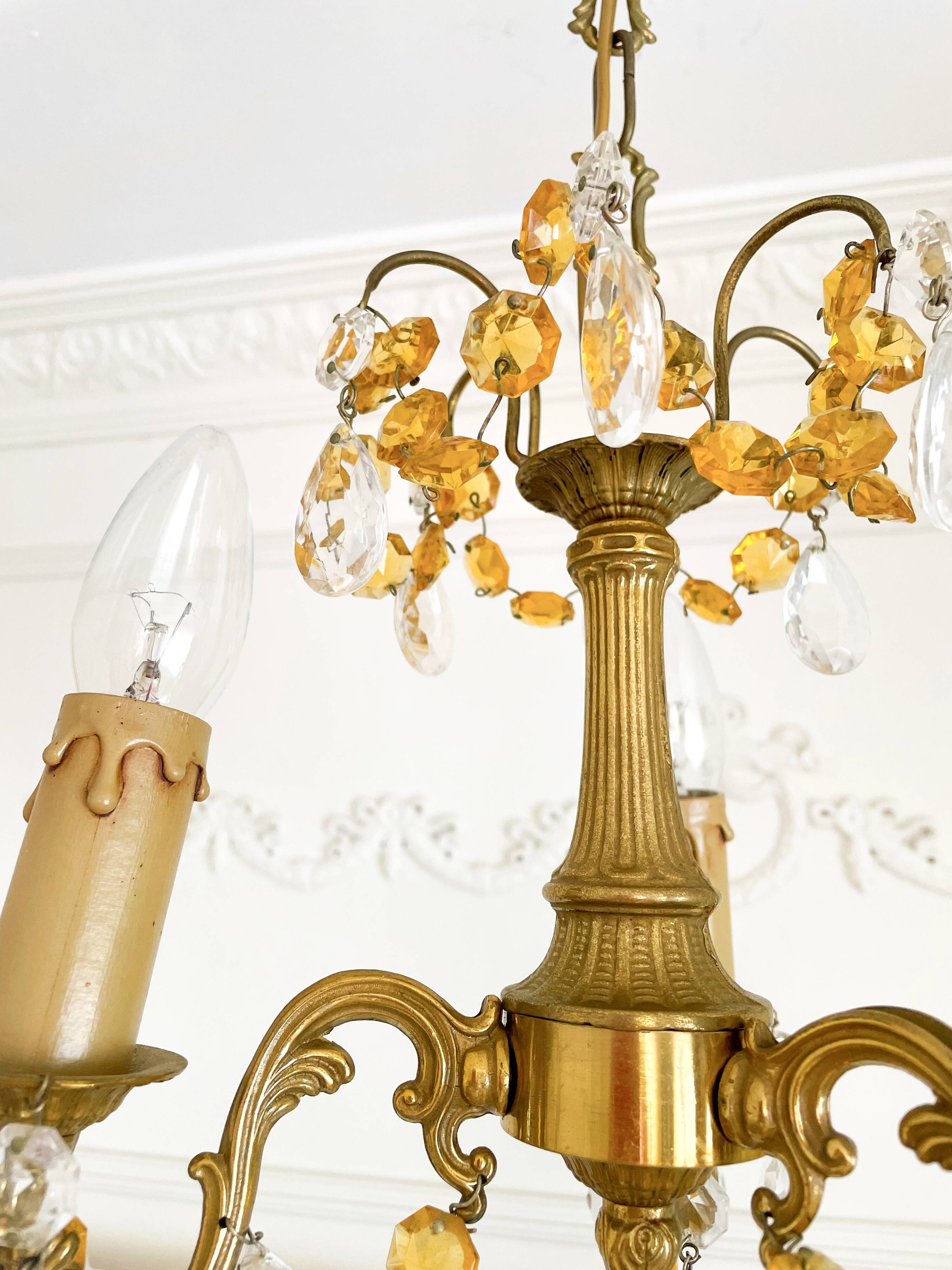 Small vintage brass chandelier with amber crystal pendants.