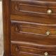 Louis XV bedside table in walnut, 3 drawers, raised edges on the tops.