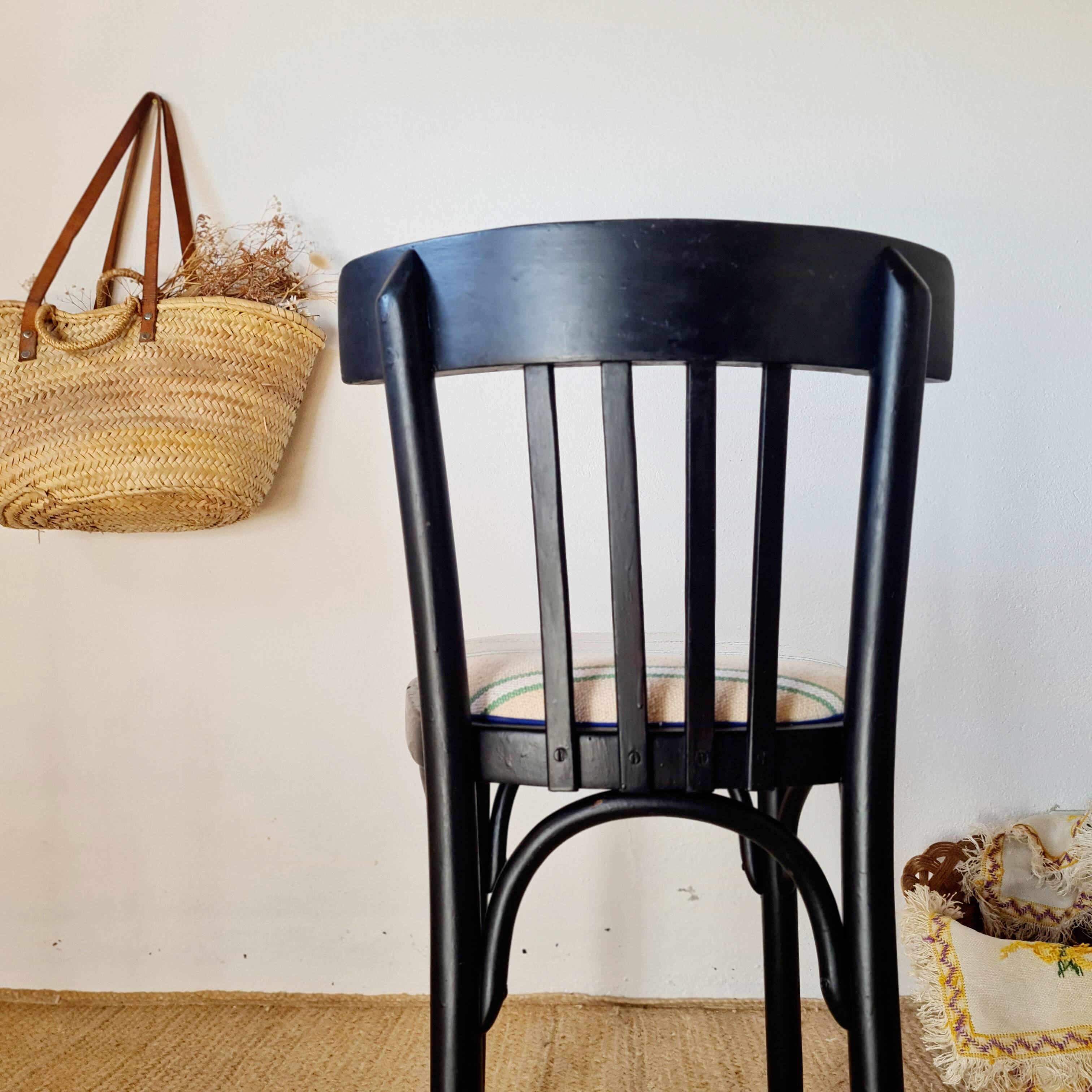 Curved black wooden bistro chair with striped seat