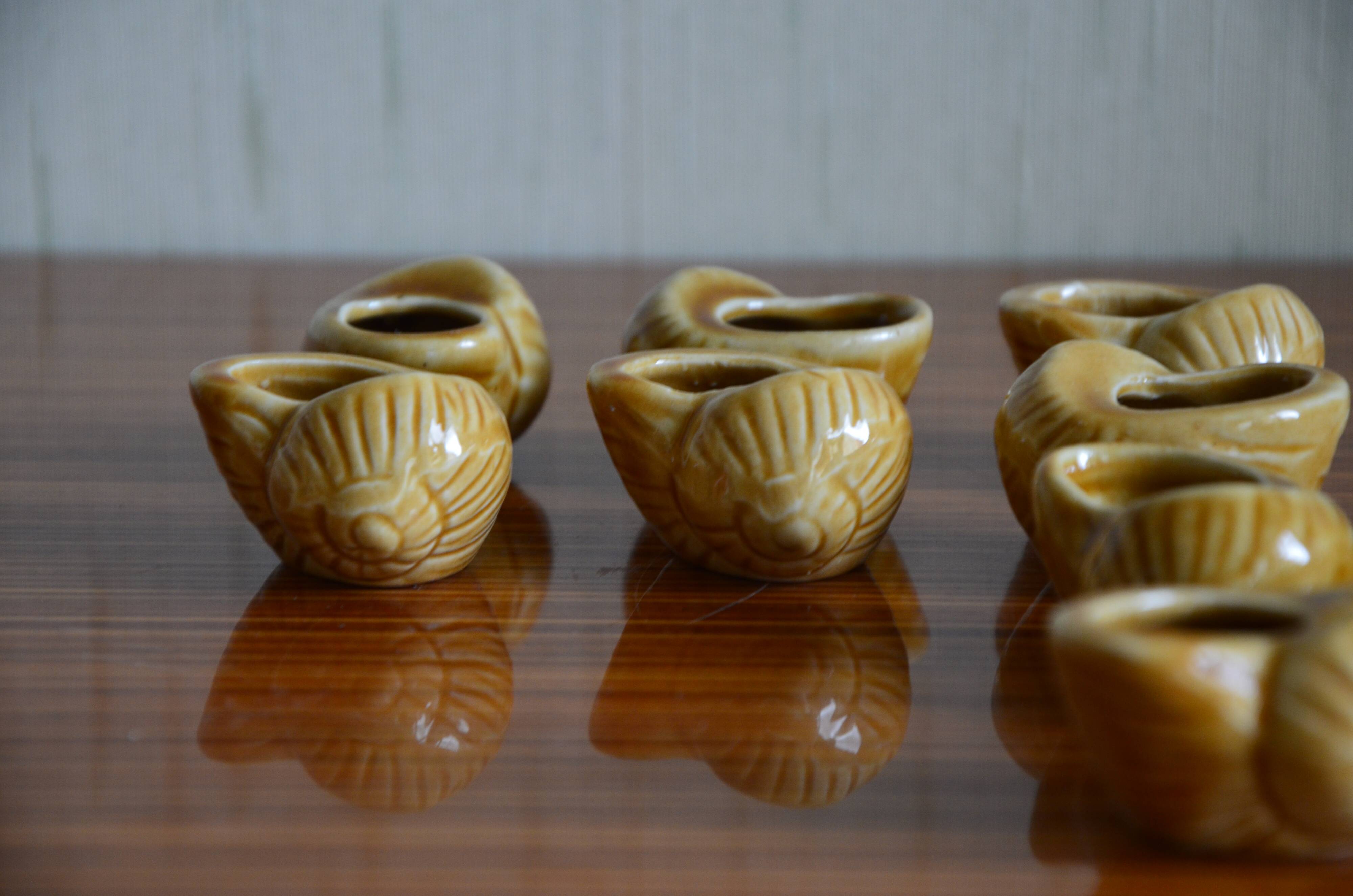 Lot of 12 enamelled sandstone snail shells