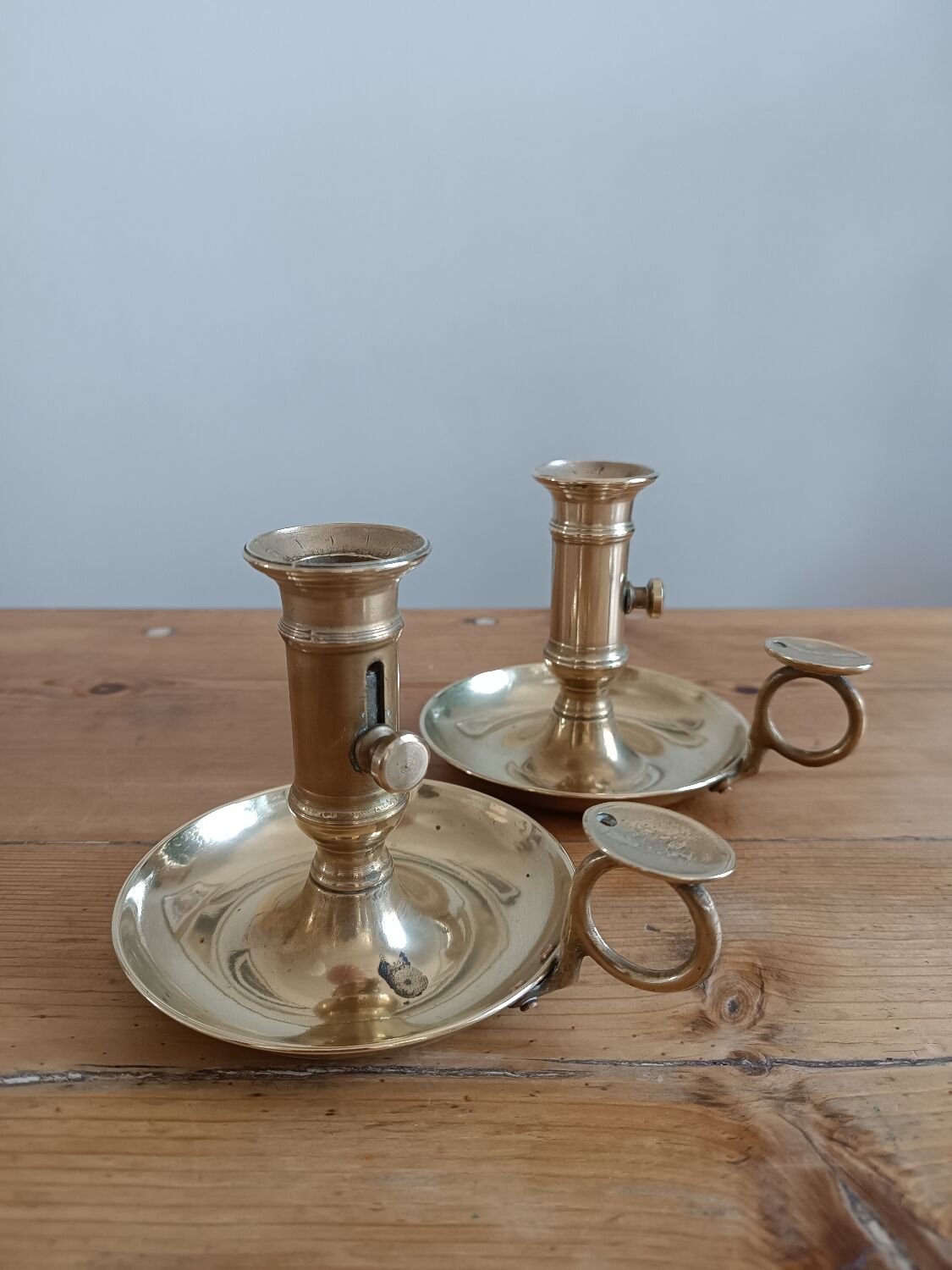 Duo of gilded brass cellar rat candlesticks