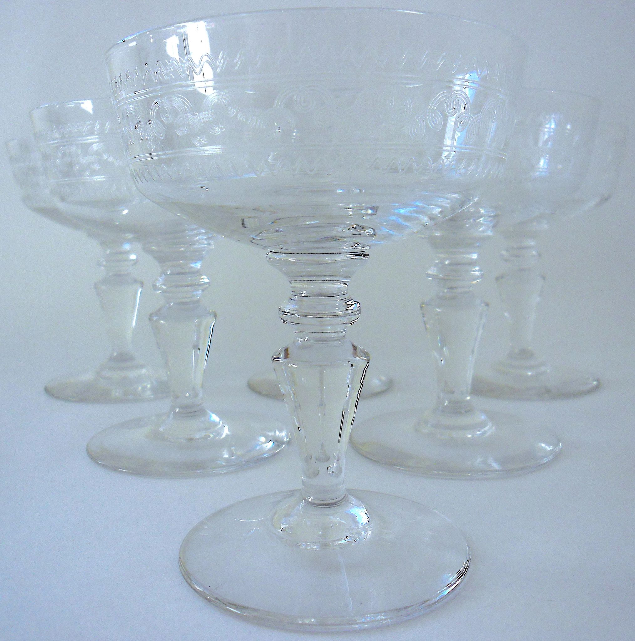 Suite of six champagne glasses on foot in engraved colorless crystal