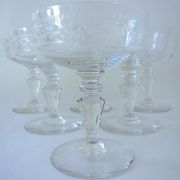 Suite of six champagne glasses on foot in engraved colorless crystal