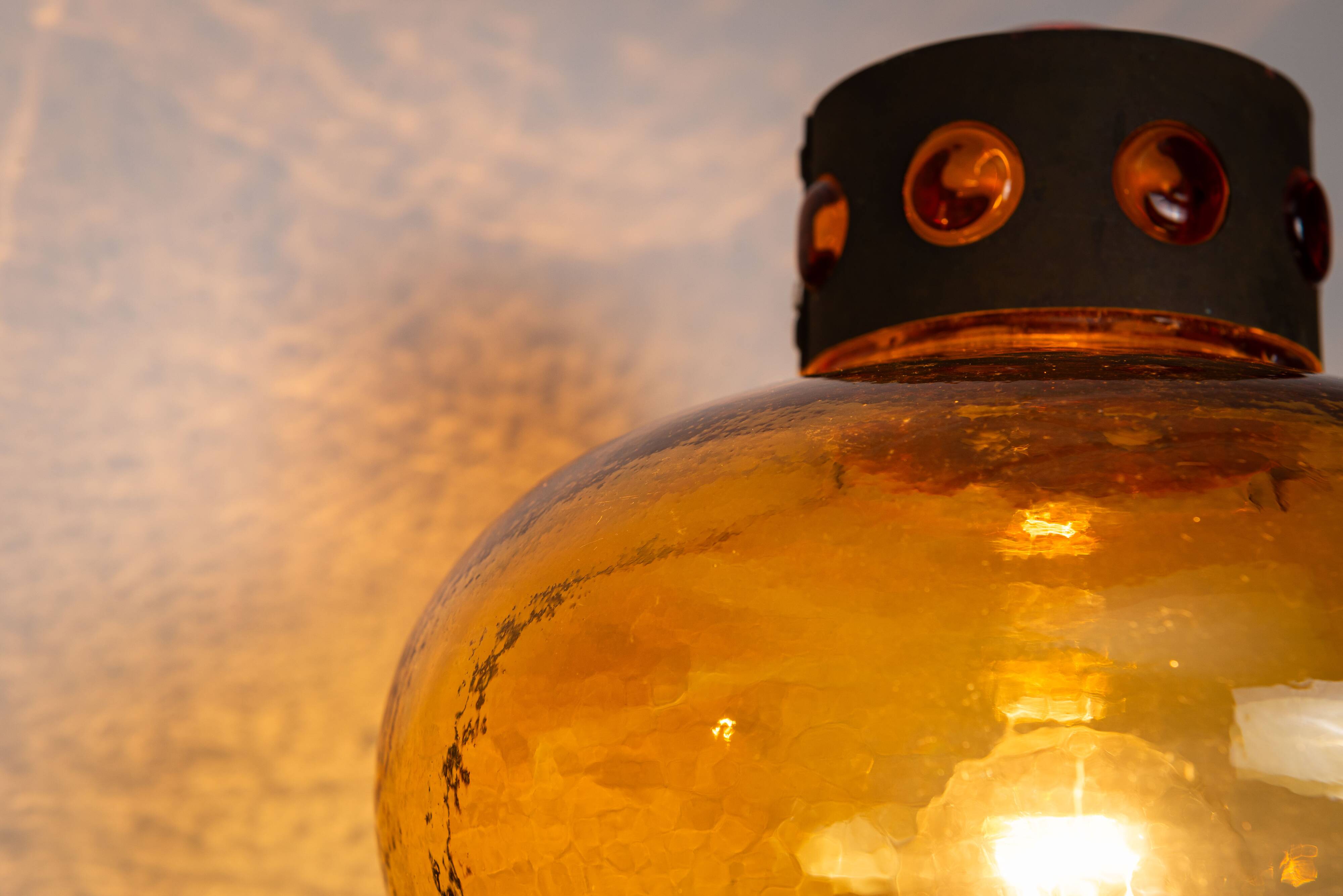 Pair of brass wall lamps with decorated amber coloured shades