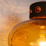 Pair of brass wall lamps with decorated amber coloured shades