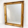 Antique mirror with a gilded frame and foliage decoration.