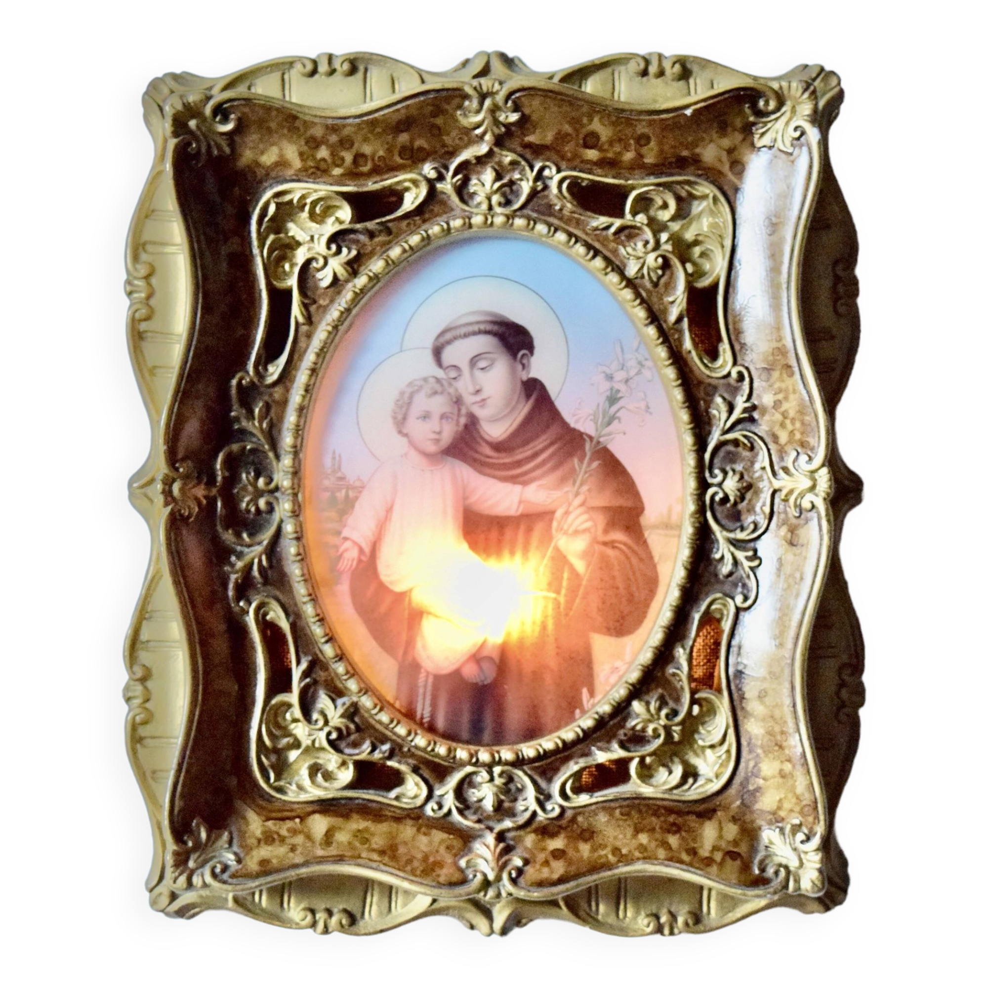 Old religious light frame in gilded stucco and curved glass