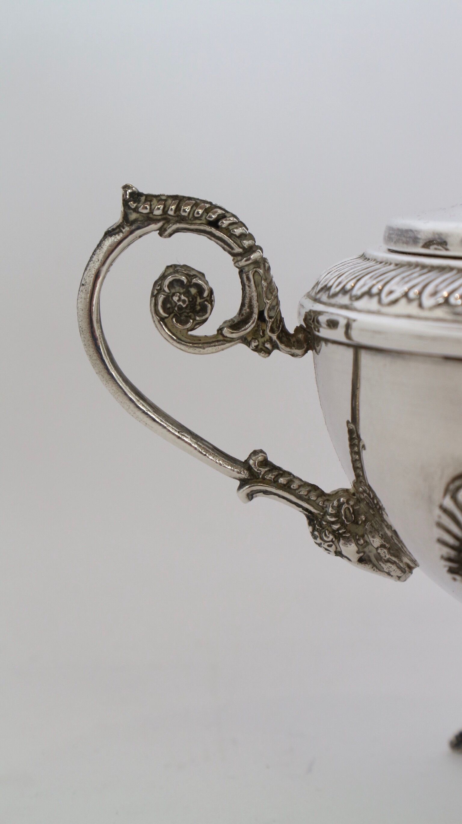 Silver sugar bowl with paw feet and ornate handles