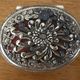 Metal jewelry box inside felt red floral decorations