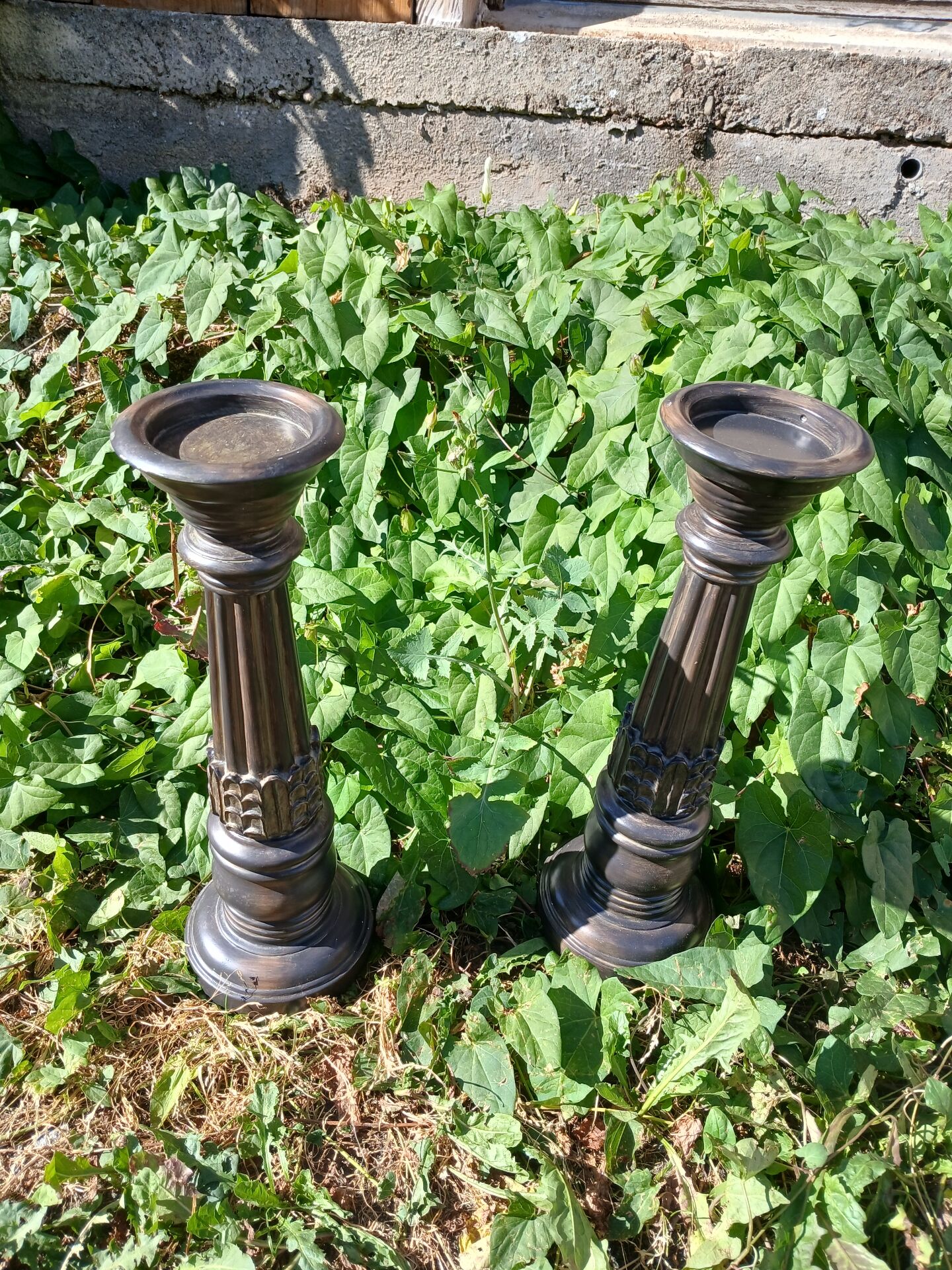2 carved wooden candlesticks