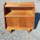 Vintage accent furniture in golden blonde oak with 2 sliding doors.