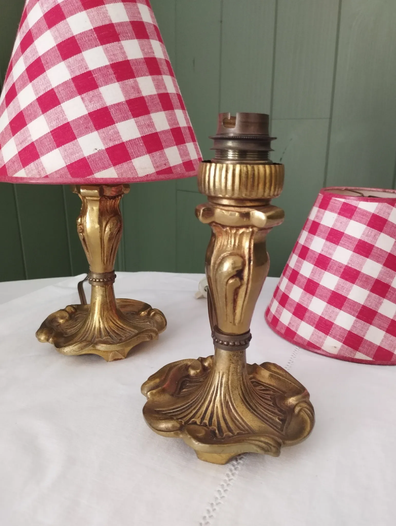 Pair of small lamps in gilded bronze by Petitot and red gingham lampshades.