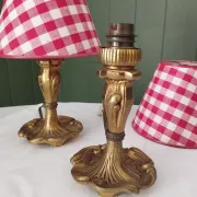 Pair of small lamps in gilded bronze by Petitot and red gingham lampshades.