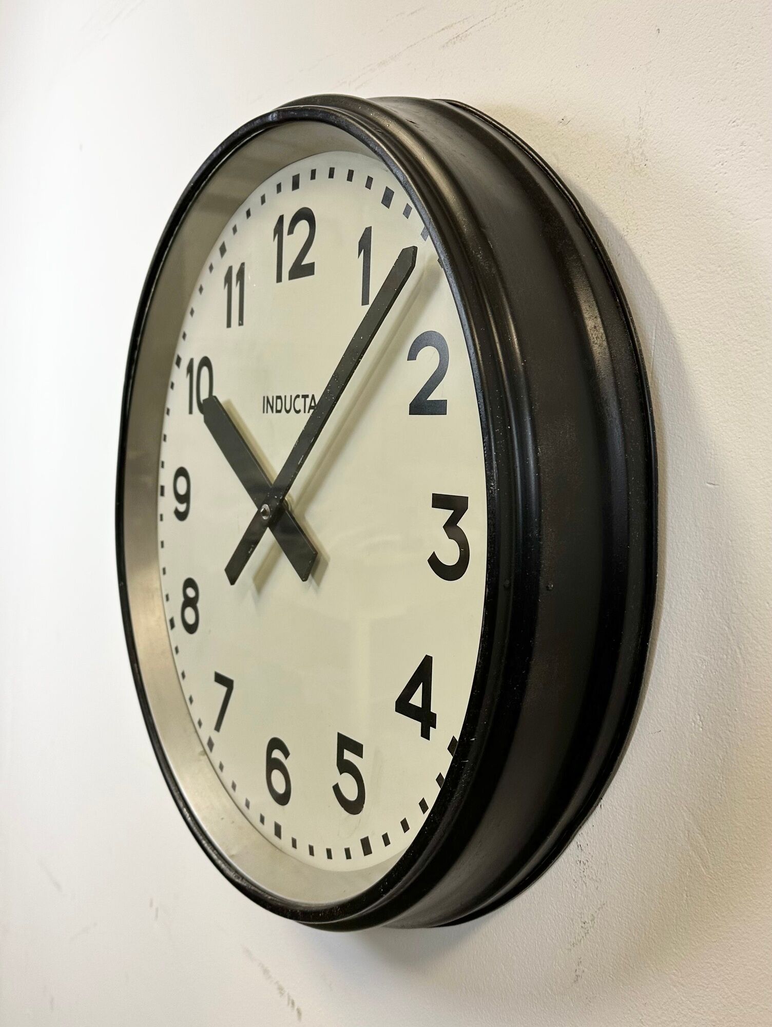 Black swiss industrial wall clock from inducta, 1960s