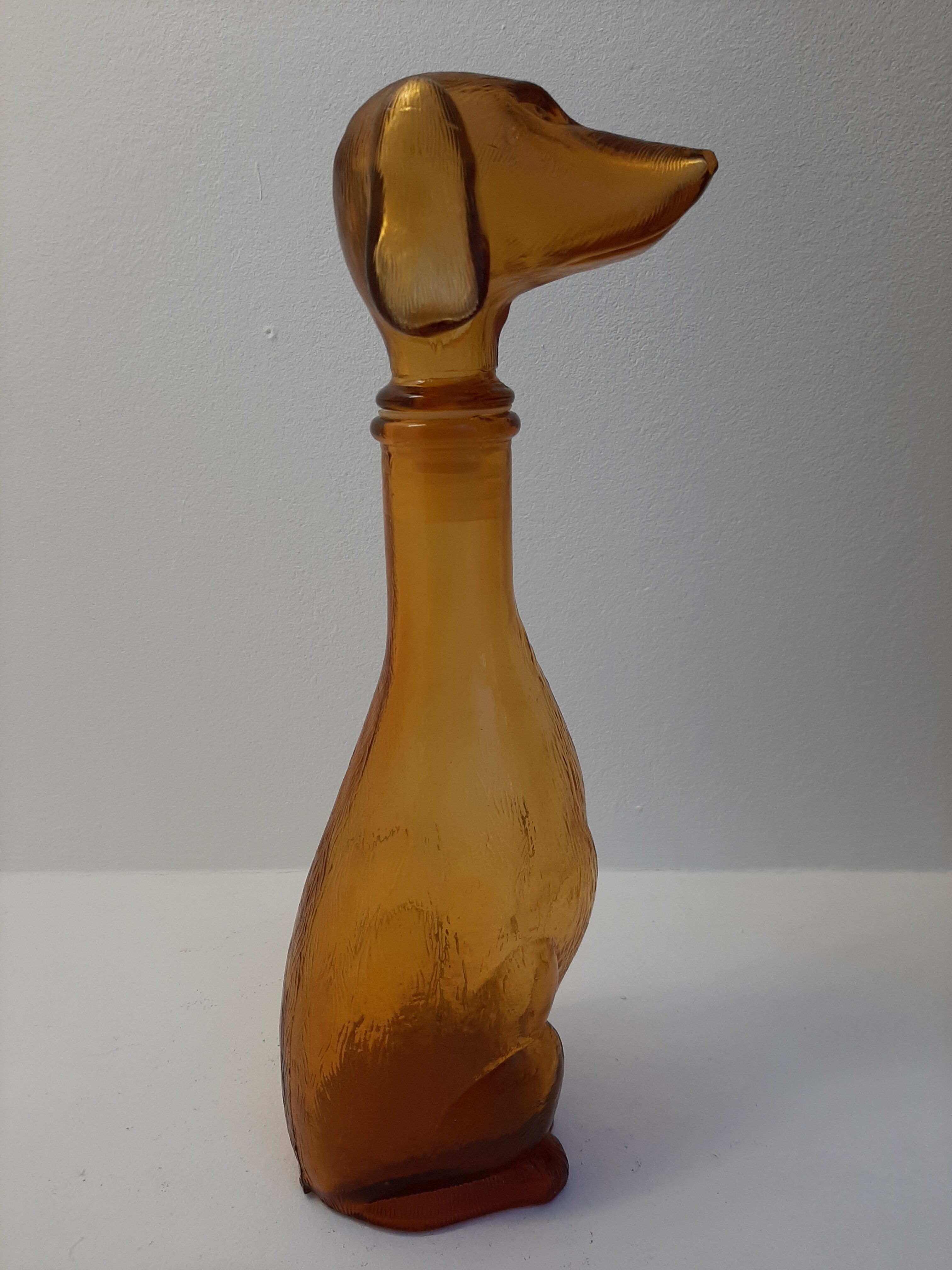Amber glass bottle representing a dog, Empoli Italy 60s