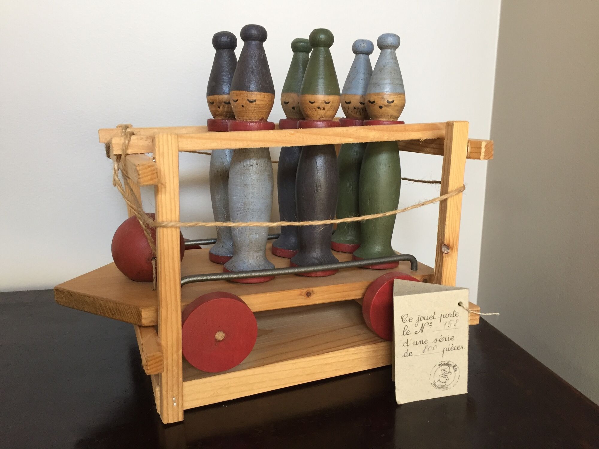 Set of Moulin Roty brand wooden bowling on roller cart, limited series.