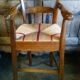 Child's high chair with a rush seat in walnut