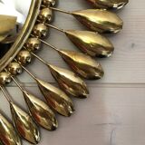 Round mirror in gilded metal
