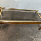 Gold metal coffee table with elm burl imitation.