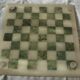 Onyx chessboard and complete wooden chess set.
