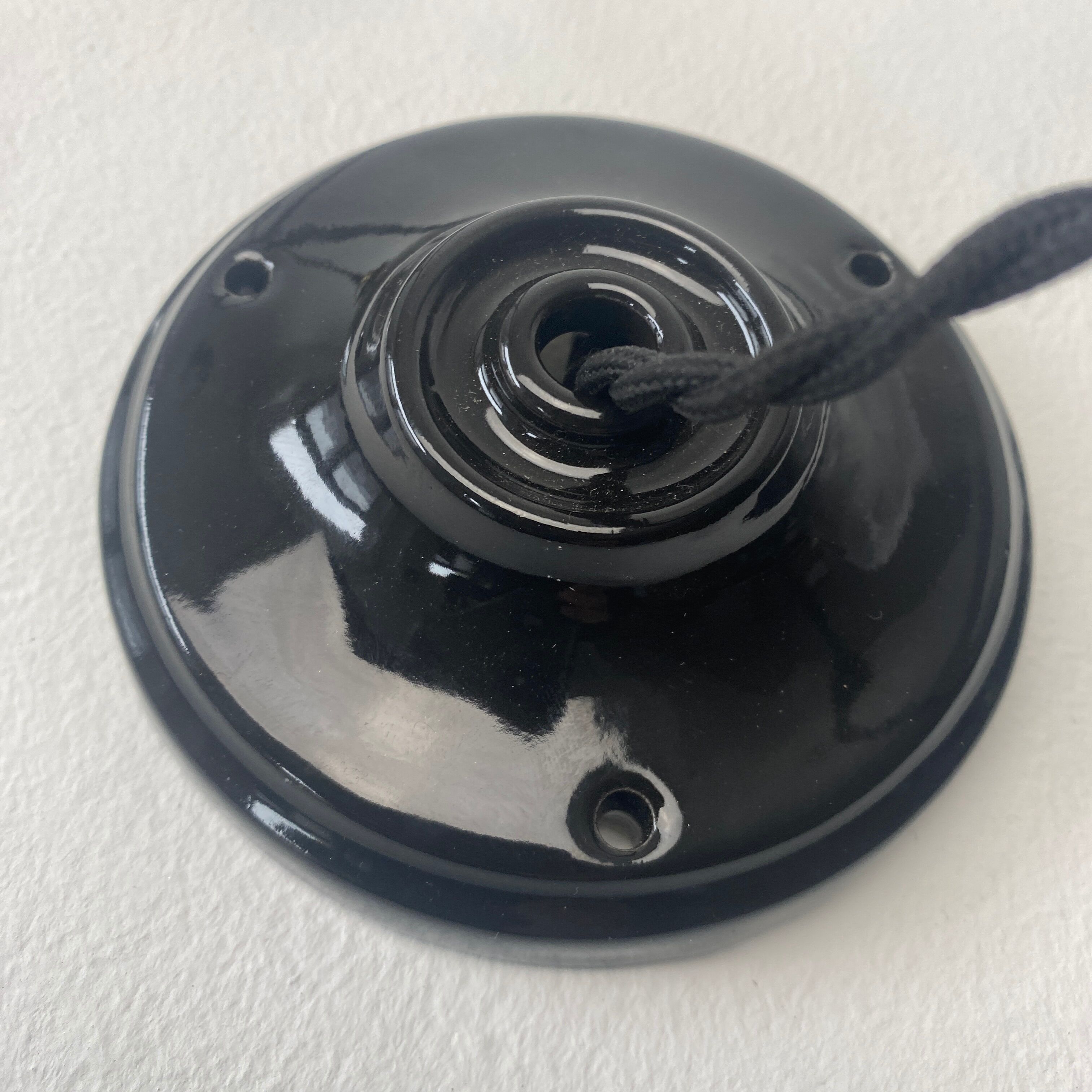 Old black enamelled industrial suspension