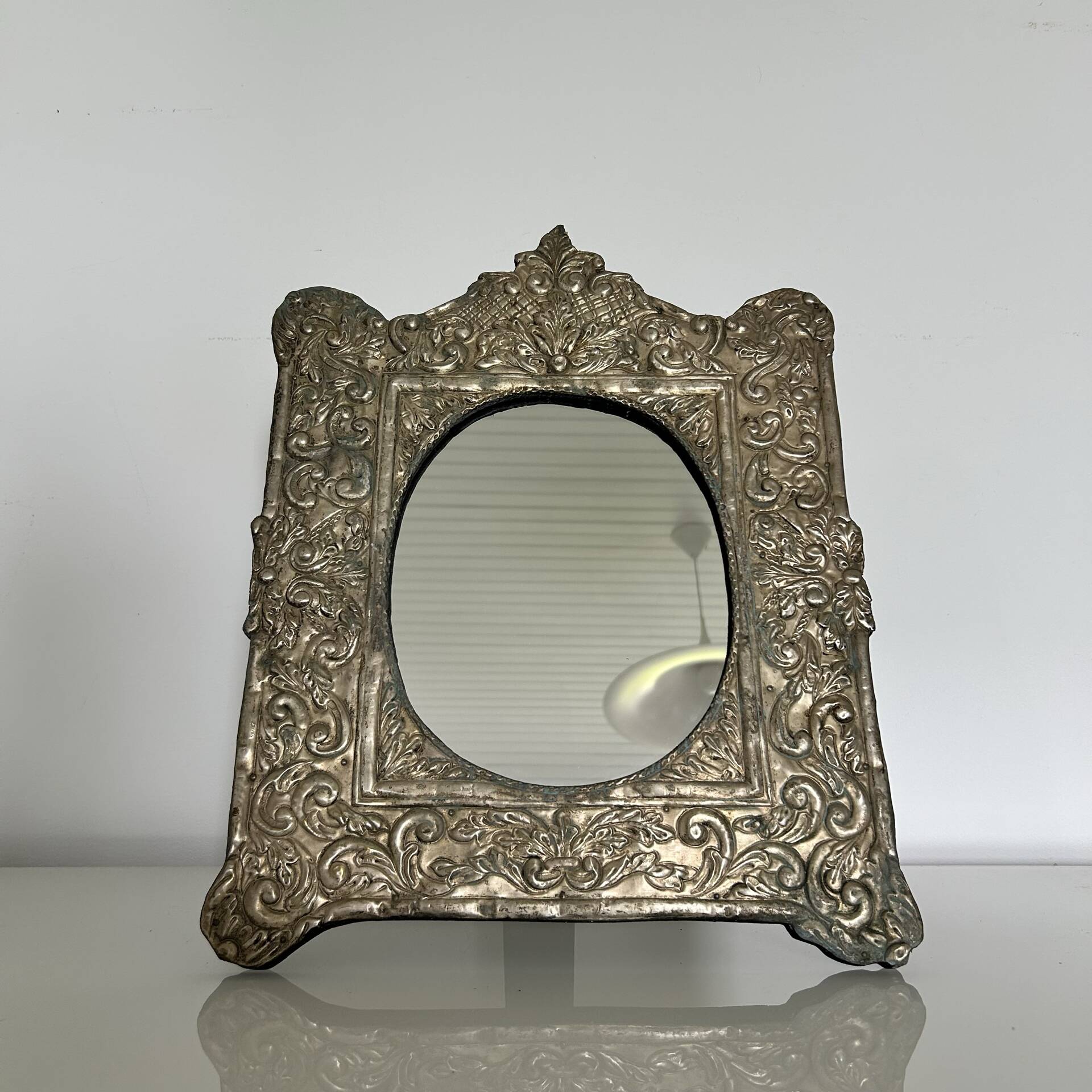 Baroque mirror in repoussé brass